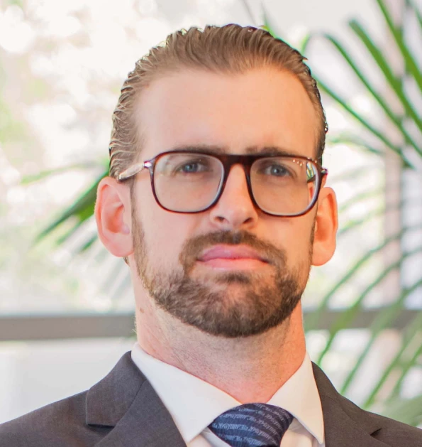 HOA attorney / HOA law A man in a suit and tie with a serious expression, looking directly at the camera.